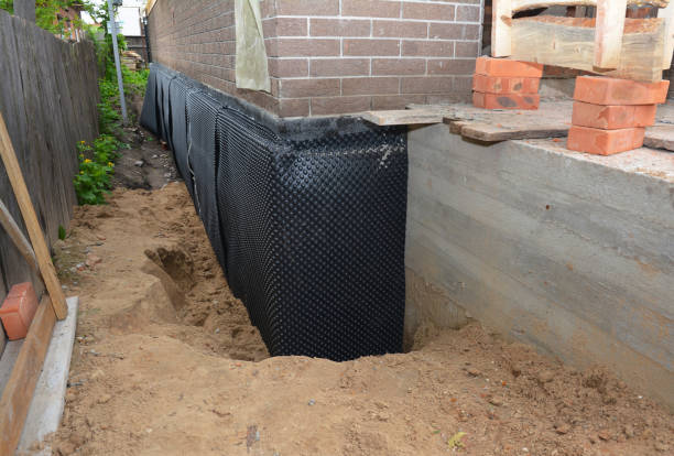 SJ Waterproofing Pros technician performing targeted Wet Basement Repair assessment in Palo, MI
